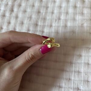 Hand holding ring - gold plated